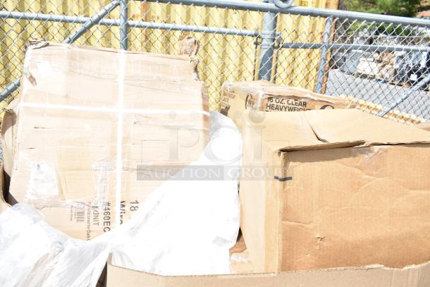 Boxes containing scratch and dent items including plates, bakery boxes, trays, foam cups. Visible labels indicate 16 oz clear cups.