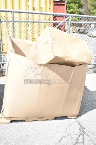 Large cardboard box on a pallet labeled "872 Feb19-04," containing 16 scratch and dent items like flush valves and folding tables.