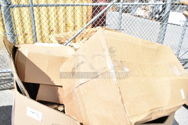 Cardboard boxes containing 16 brand new scratch and dent items, including a flush valve, toast chute, chair cover, and folding table.
