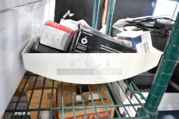 6 brand new scratch and dent items, including Relay 940-0001-61 and Hubbell battery, in packaging on shelf.