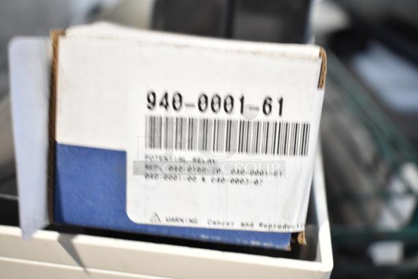 Box labeled "940-0001-61 Relay," new condition with visible barcode and warning labels. Part of auction item set.