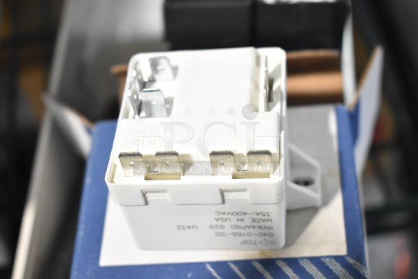 White relay with metal prongs marked 940-0166-20, 35A-400VAC, made in USA. Scratch and dent condition.