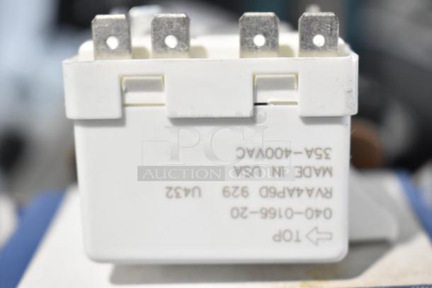 White electrical relay, model 940-0001-61, brand new with scratch and dent condition. Marked "35A-400VAC Made in USA".