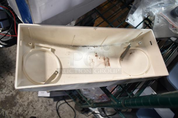 Plastic housing unit, light beige, with circular cutouts and minor dirt. Ideal for electrical components.