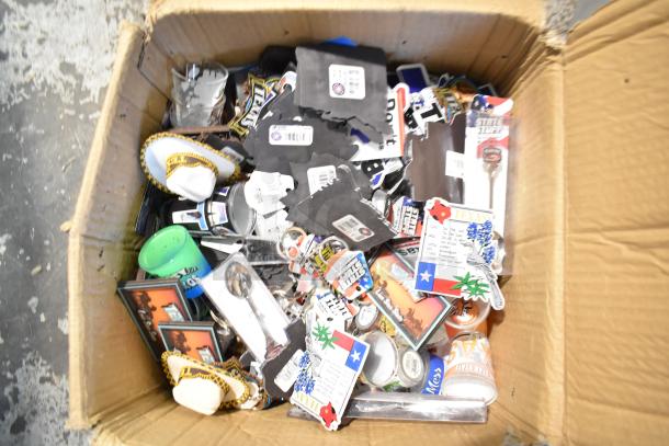 Lot of Texas-themed items including pins, spoon, and shot glasses in a cardboard box; various paraphernalia visible.
