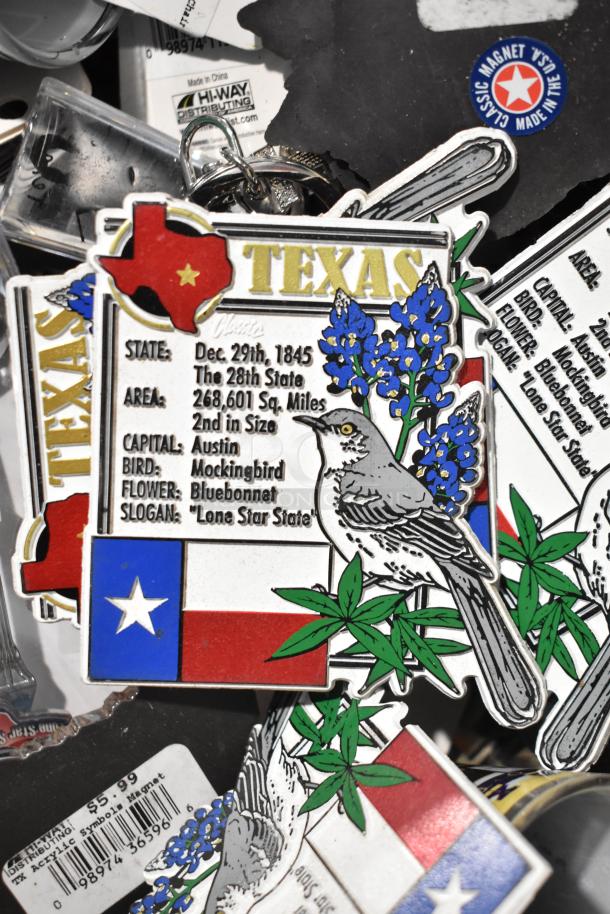 Lot of Texas-themed items including state magnets with bluebonnet and mockingbird design, along with various small collectibles.