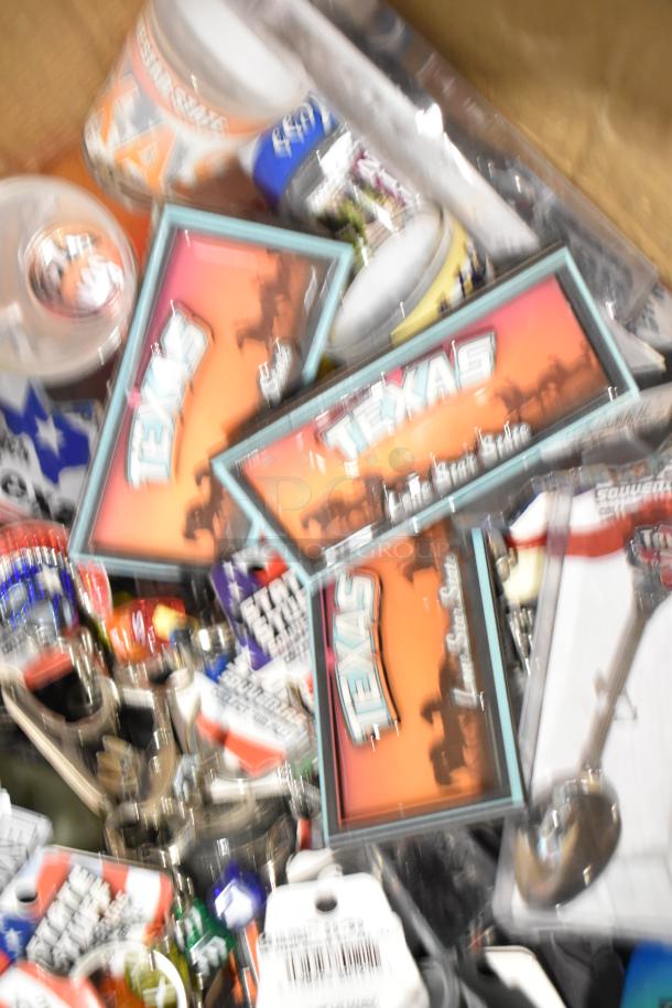 Lot of Texas-themed items, including Texas paraphernalia signs, pins, spoon, shot glasses in mixed condition.