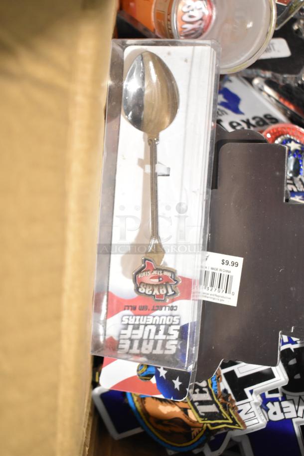 Lot of Texas-themed items including a souvenir spoon labeled "Texas State Souvenirs," pins, and a shot glass.