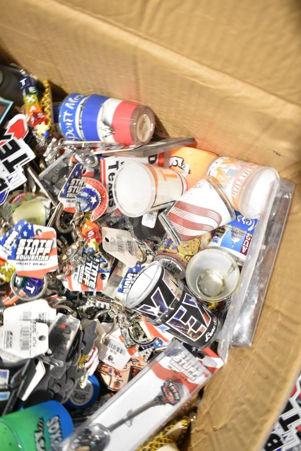 Box of assorted Texas items, including themed pins, spoons, shot glasses, and keychains. Various conditions, some tagged.