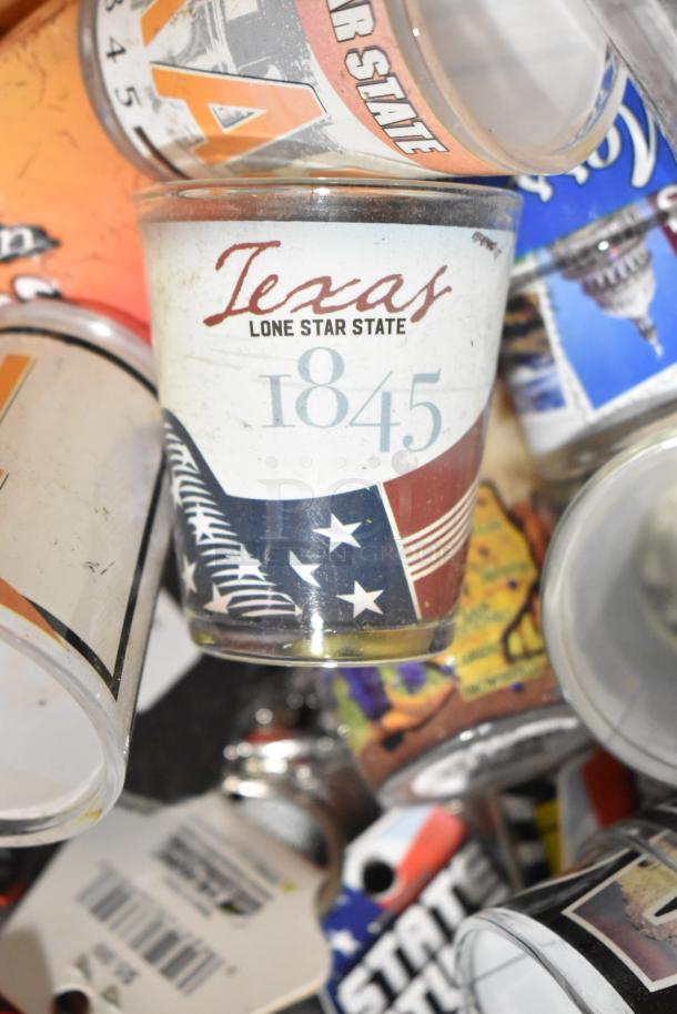 Lot of various items including Texas-themed shot glasses, pins, spoon, and paraphernalia. Highlight: Texas 1845 design.
