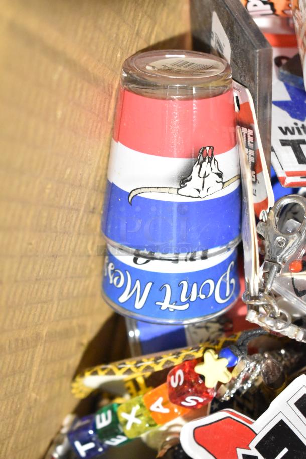Lot of Texas paraphernalia, including shot glasses, pins, and spoon, featuring vibrant colors and various designs.