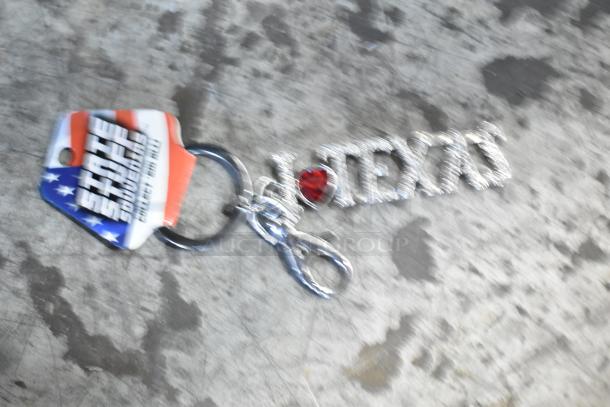 Keychain with "I ❤️ TEXAS" design, featuring a red heart and silver text. Attached to a ring with a "State Souvenirs" tag.