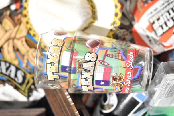 Lot of Texas-themed items including decorative spoon and shot glasses with "Texas" and "Lone Star State" text.