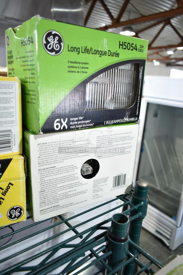 Box of GE H5054 Long Life halogen headlamps, 12V, 2 headlamp system, 6X longer life, in original packaging, on metal shelf.