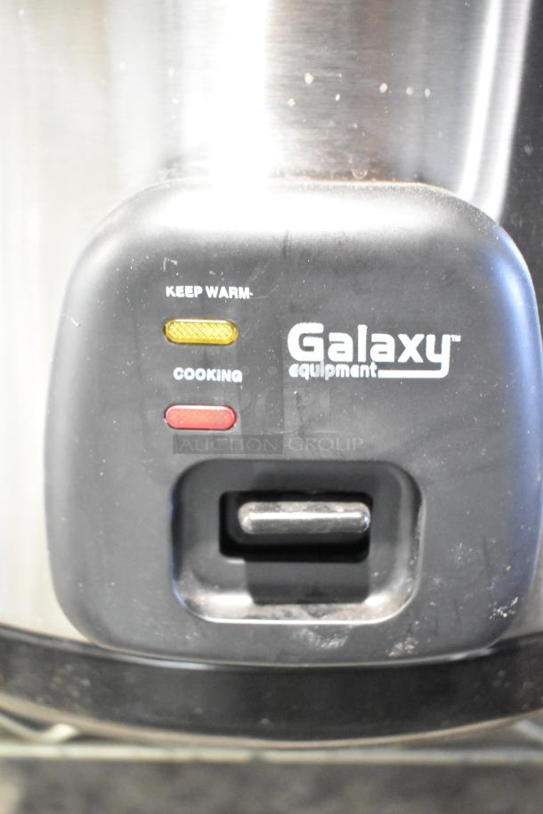 Brand new Galaxy 177RCSG60 rice cooker, 60-cup capacity, 120V, 1 phase. Features "Keep Warm" and "Cooking" indicators.