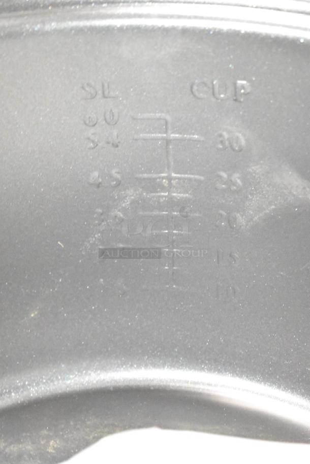 Close-up view of interior measurement markings on a Galaxy 177RCSG60 rice cooker, showing raw and cooked cup levels.
