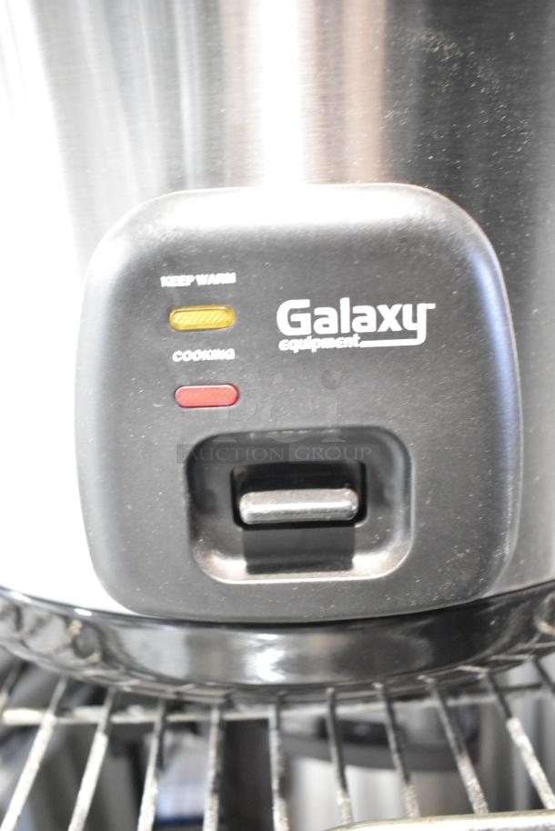 Brand new Galaxy 177RCSG60 electric rice cooker, 60 cup capacity, with "Keep Warm" and "Cooking" indicators visible.