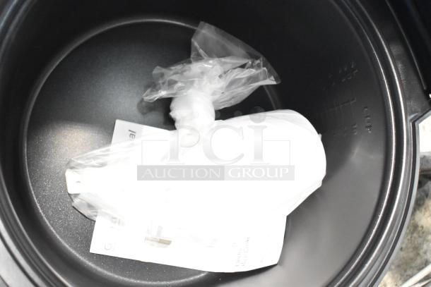 Brand new Galaxy 177RCSG60 electric rice cooker with 60 cup capacity, includes manual and accessories in original packaging.