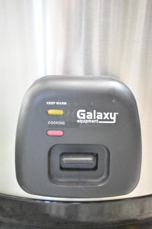 Galaxy 177RCSG60 electric rice cooker in new condition. Features keep warm and cooking indicators. 60 cup capacity, 120V.