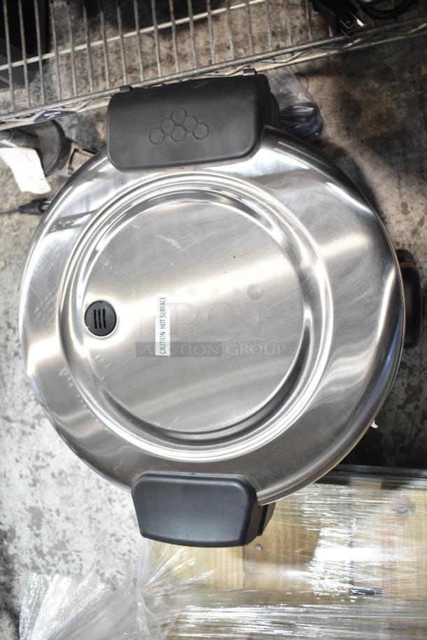 Brand new Galaxy 177RCSG60 countertop electric rice cooker/warmer, 60 cup capacity, scratch and dent condition, labeled "caution: hot surface."