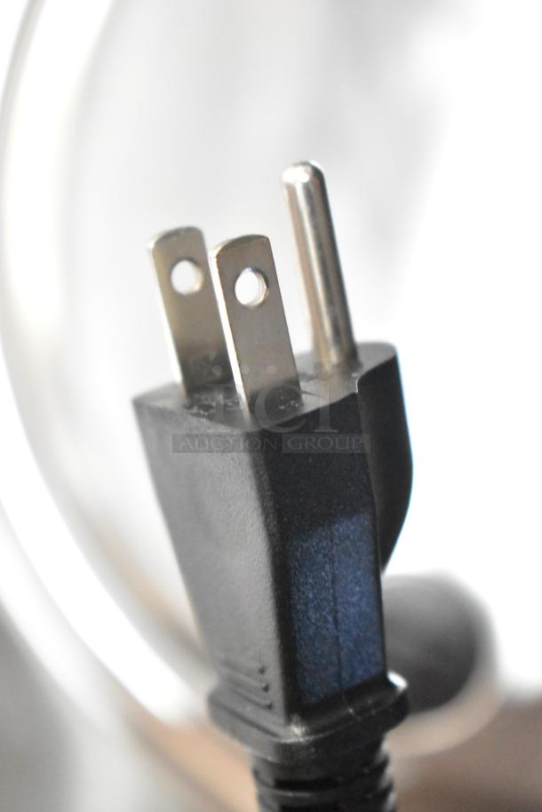 Close-up of the power plug for a 2024 Galaxy 177RCSG60 electric rice cooker, 120 volts, brand new condition.