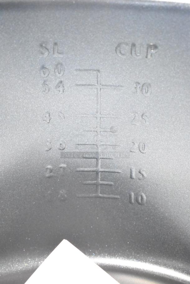 Embossed interior measurement markings in a Galaxy 177RCSG60 60-cup electric rice cooker.