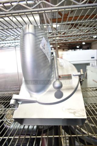 Commercial Pelican Head with grating blade, metallic finish, lever mechanism, warning label visible, used condition.