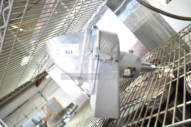 Commercial pelican head with grating blade, made of durable metal, marked "176," in excellent condition, on a metal rack.