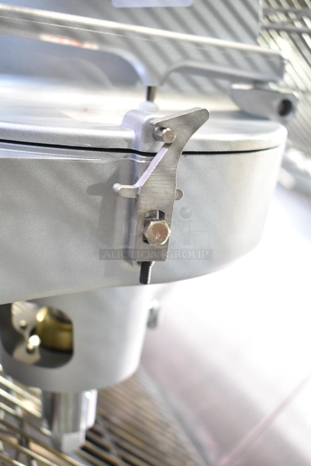 Commercial Pelican Head with grating blade, metal construction, close-up of locking mechanism, appears in good condition.