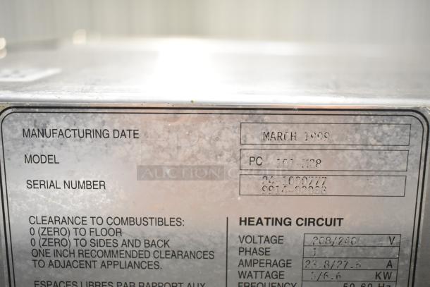 Baxter PC101-M28 commercial roll-in rack, 208/240V, 1 phase. Manufacturing date March 1999, serial numbers visible.