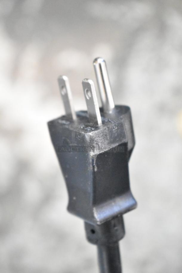 Close-up of a three-prong electric plug for the 2025 Cadco Unox Anna XAF023-US convection oven.