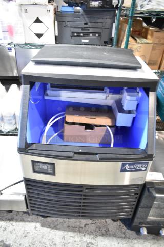 Brand new Avantco commercial ice machine, scratch and dent condition, self-contained unit with visible spare parts box inside.