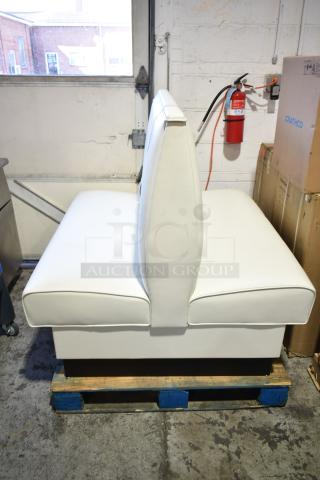 White double-sided booth seat, upholstered in smooth vinyl. Appears in good condition, ideal for commercial use.