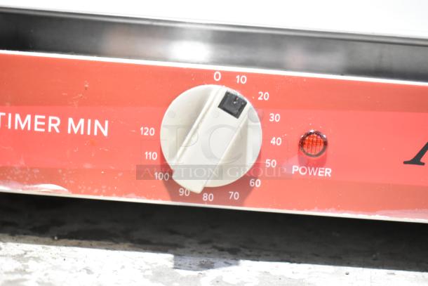 Close-up of Avantco 177CO16 convection oven control panel with timer dial and power indicator light.