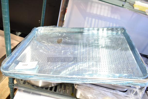 14 new scratch and dent aluminum and stainless steel pans, including a perforated bun pan, anti-jam steam table pans; some wrapped in plastic.