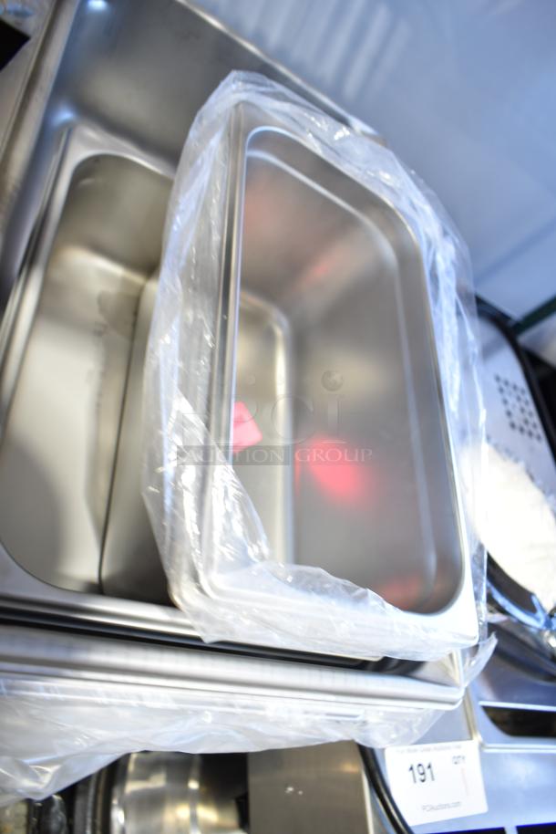Auction lot of 14 new scratch and dent pans, including wire rim aluminum and anti-jam stainless steel steam table pans.