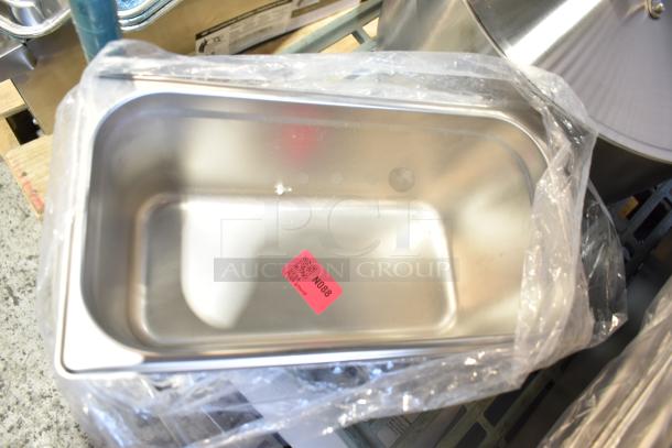 14 scratch and dent items, including stainless steel steam table pans and aluminum sheet pans, still in packaging. Pink tag N088 visible.