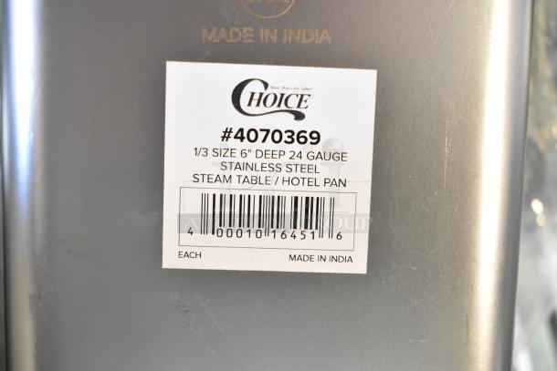 Close-up of label on Choice 1/3 Size 6" Deep 24 Gauge Stainless Steel Steam Table Pan, made in India.