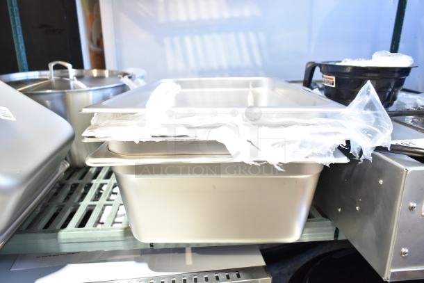 14 brand new scratch and dent kitchen items, including stainless steel steam table pans and aluminum sheet pans.