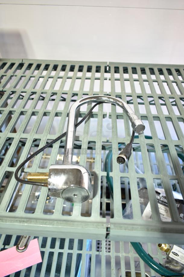 Chrome 020237-45 power unit with attached black cable on green grid shelf, part of eight-item auction set.