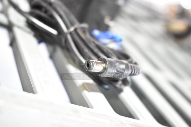 8 various items including a 020237-45 Power Unit cable, shown coiled on a metal surface, indicating functional condition.