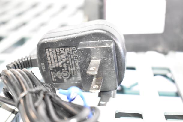 Eight assorted items, including a power unit model 020237-45, shown with visible plug and label details.