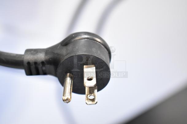 Close-up of a standard three-prong power plug for a True TSCI-600R-G-PH cooler, showing details of the prong alignment.