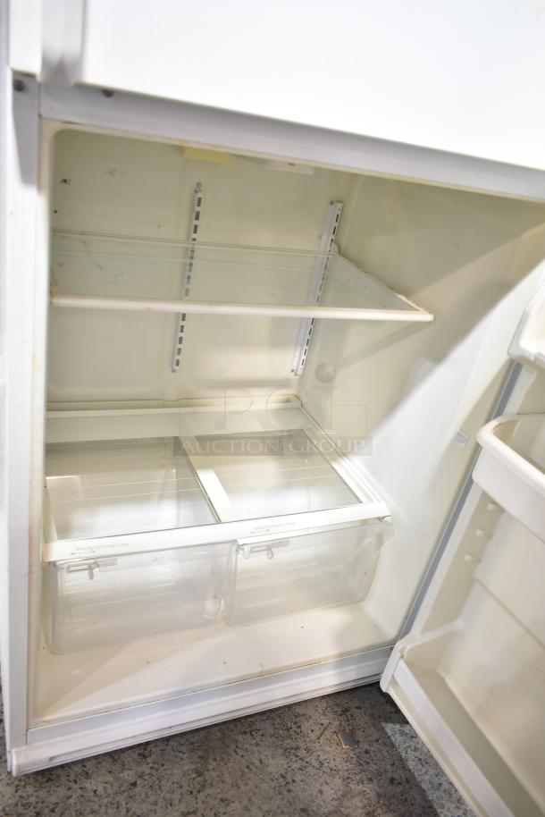 Whirlpool ET1MHKXMQ08 reach-in cooler with freezer, 115 volts, 1 phase, interior view showing shelves and crisper drawers.