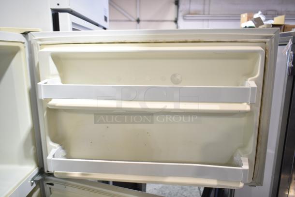 Whirlpool ET1MHKXMQ08 reach-in cooler and freezer, 115V, 1 phase, open white interior with door shelving, good condition.