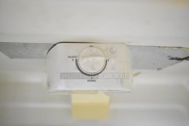 Whirlpool ET1MHKXMQ08 cooler/freezer temperature dial, showing settings from coldest to normal. Visible wear on dial.