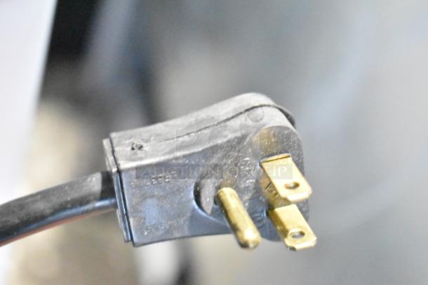 Electrical plug of Habco SF28M Commercial Freezer Merchandiser, 115 volts, showing three-prong configuration.