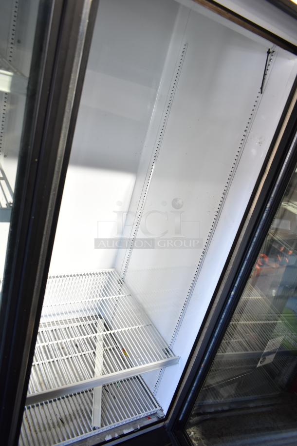 True GDM-72-HC-LD commercial 3-door cooler merchandiser, 115 volts, 1 phase, clean interior, adjustable shelves.