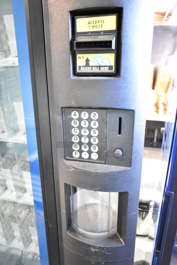 Crane 5800-4 commercial vending machine with bill acceptor, keypad, and clear display window. 115 volts, 1 phase.