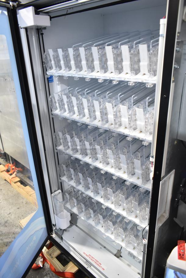 Crane 5800-4 metal commercial bottled drink vending machine with bill acceptor, internal view showing slots and labels.
